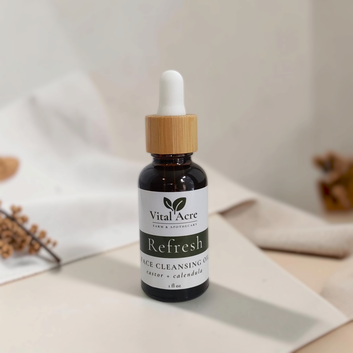 Vital Acre Farm & Apothecary Refresh face cleansing oil in an amber glass bottle with a bamboo dropper cap.