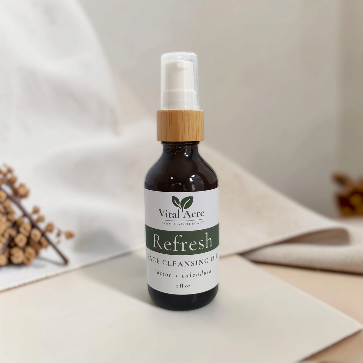 Vital Acre Farm & Apothecary Refresh face cleansing oil in a dark amber glass bottle with a bamboo pump dispenser.