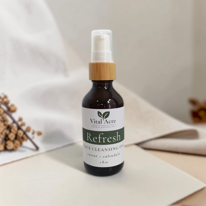 Vital Acre Farm & Apothecary Refresh face cleansing oil in a dark amber glass bottle with a bamboo pump dispenser.