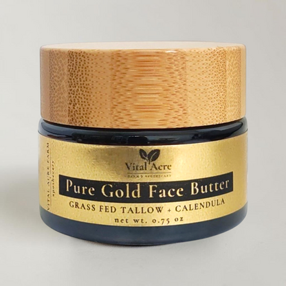 A jar of Vital Acre Pure Gold Face Butter with a light wood lid and a gold label, set against a plain light background.