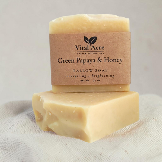 Vital Acre Farm & Apothecary Green Papaya & Honey tallow soap bars with a rustic paper label on a stone surface.