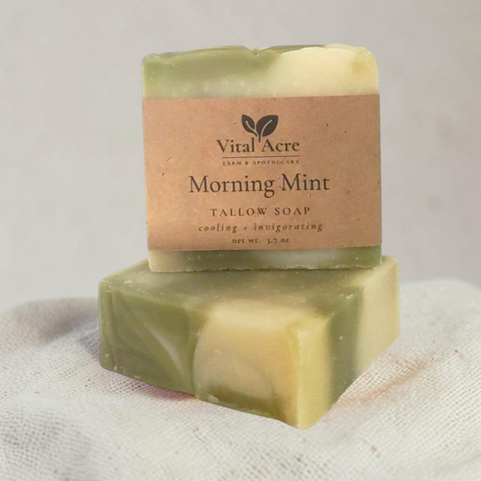 Vital Acre Farm & Apothecary peppermint tallow soap bar with green and cream swirls and a paper label
