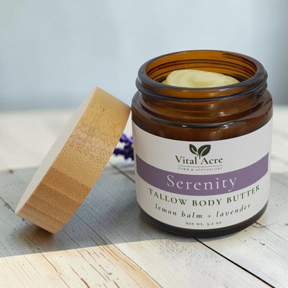 Vital Acre Farm & Apothecary Serenity tallow body butter in an amber glass jar with a wooden lid and lavender label.