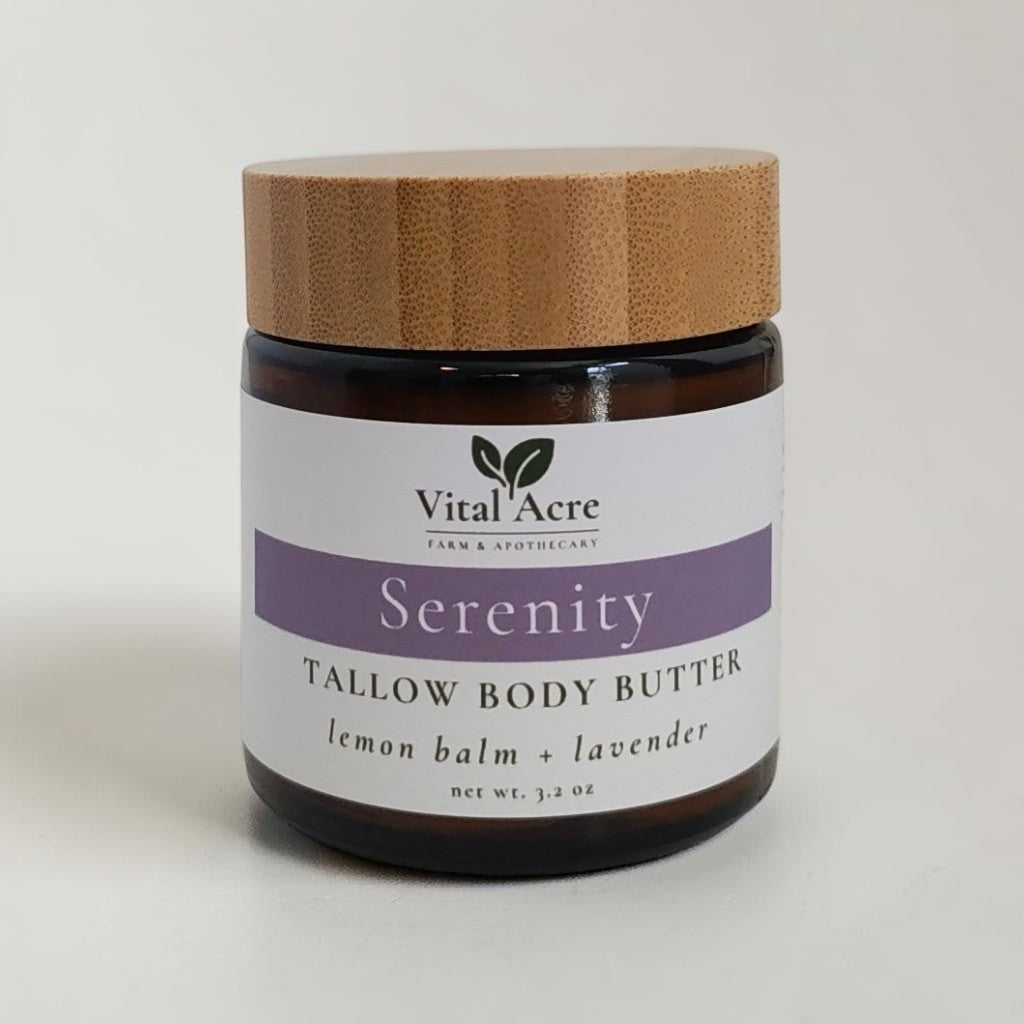 Vital Acre Farm & Apothecary Serenity tallow body butter in an amber glass jar with a bamboo lid.