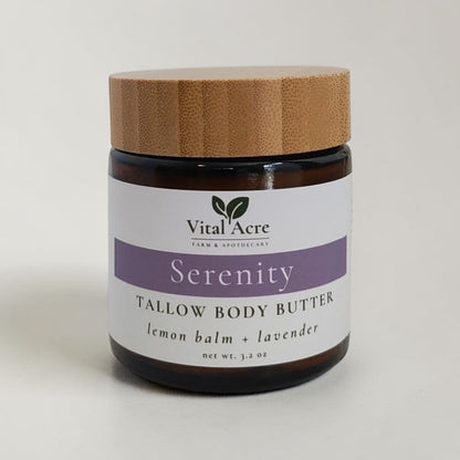 Vital Acre Farm & Apothecary Serenity tallow body butter in an amber glass jar with a bamboo lid.